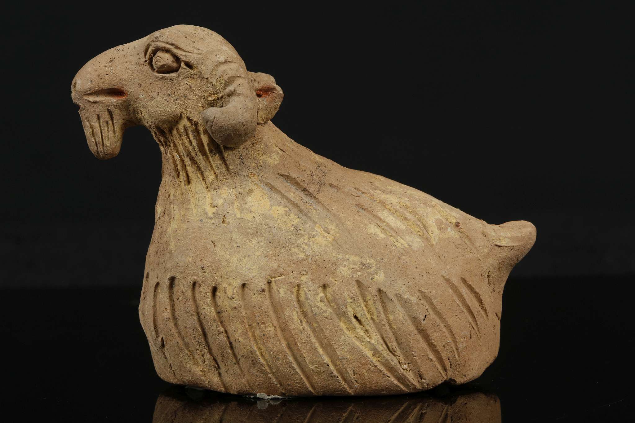 A PAINTED POTTERY GOAT. Yuan Dynasty. Modelled seated with the head slightly raised, with details - Image 4 of 7