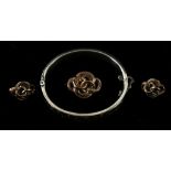 A silver bangle overlayed with 9ct gold, together with a Victorian brooch and a clip on earring