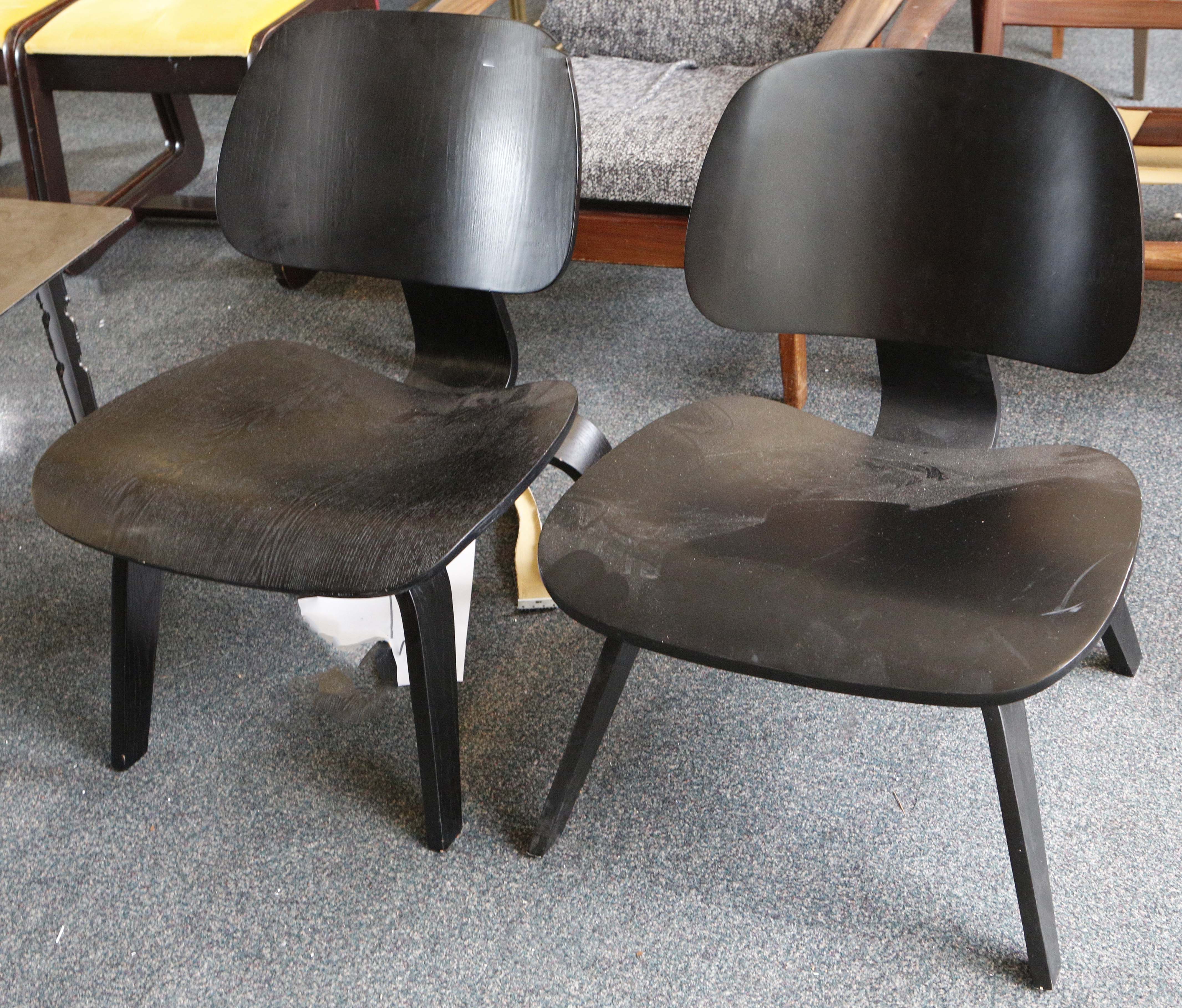 A pair of ebonised ash Charles Eames L.C.W. chairs