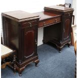 An Edwardian mahogany sideboard with central drawer over an open recess flanked by two pedestals,