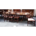 A mahogany Georgian style D end dinning table on twin pedestals to include two extra leaves together