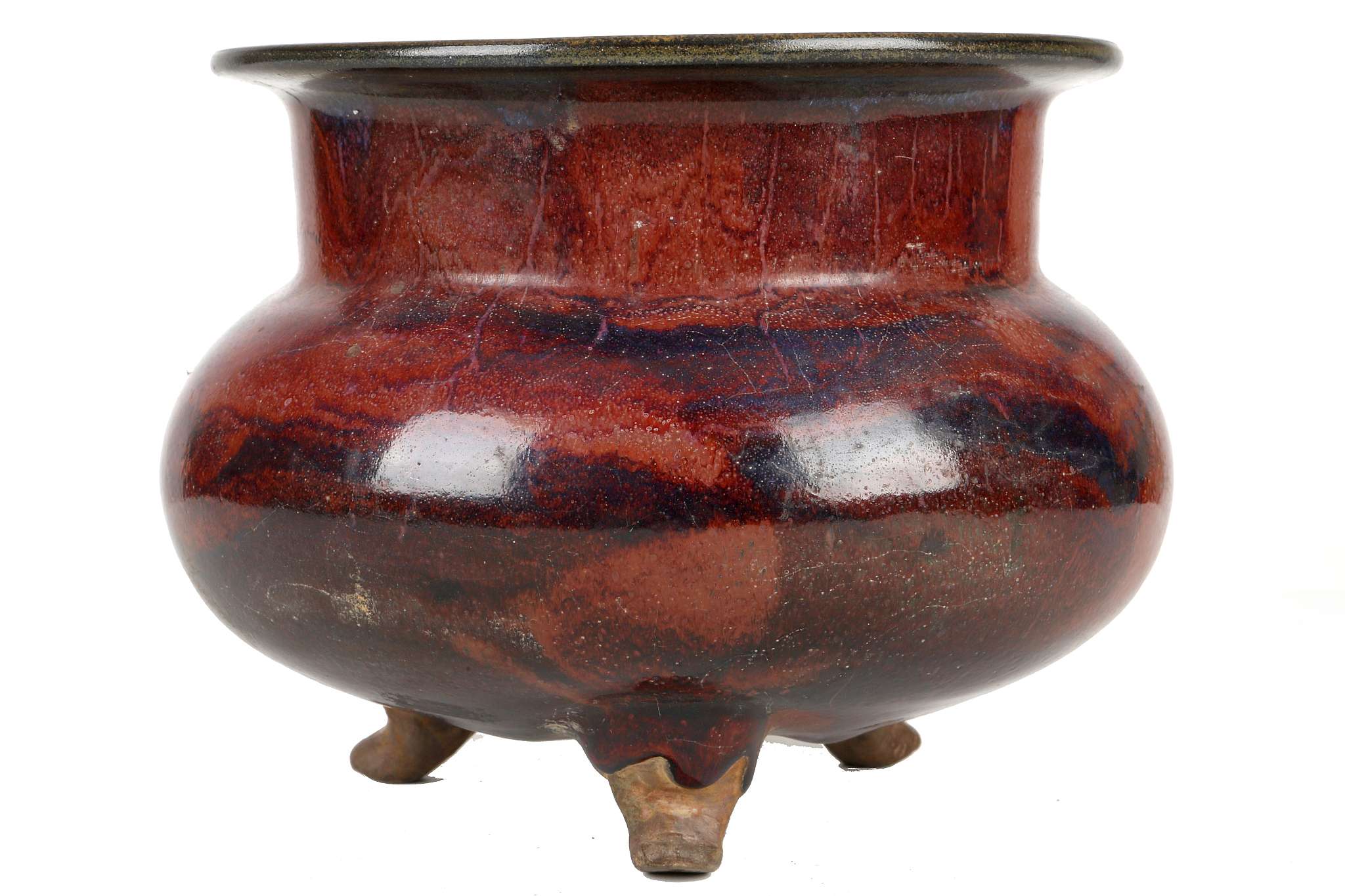 A CHINESE JUN TYPE TRIPOD CENSER. Early 20th Century. The compressed globular body raised on three