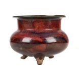 A CHINESE JUN TYPE TRIPOD CENSER. Early 20th Century. The compressed globular body raised on three