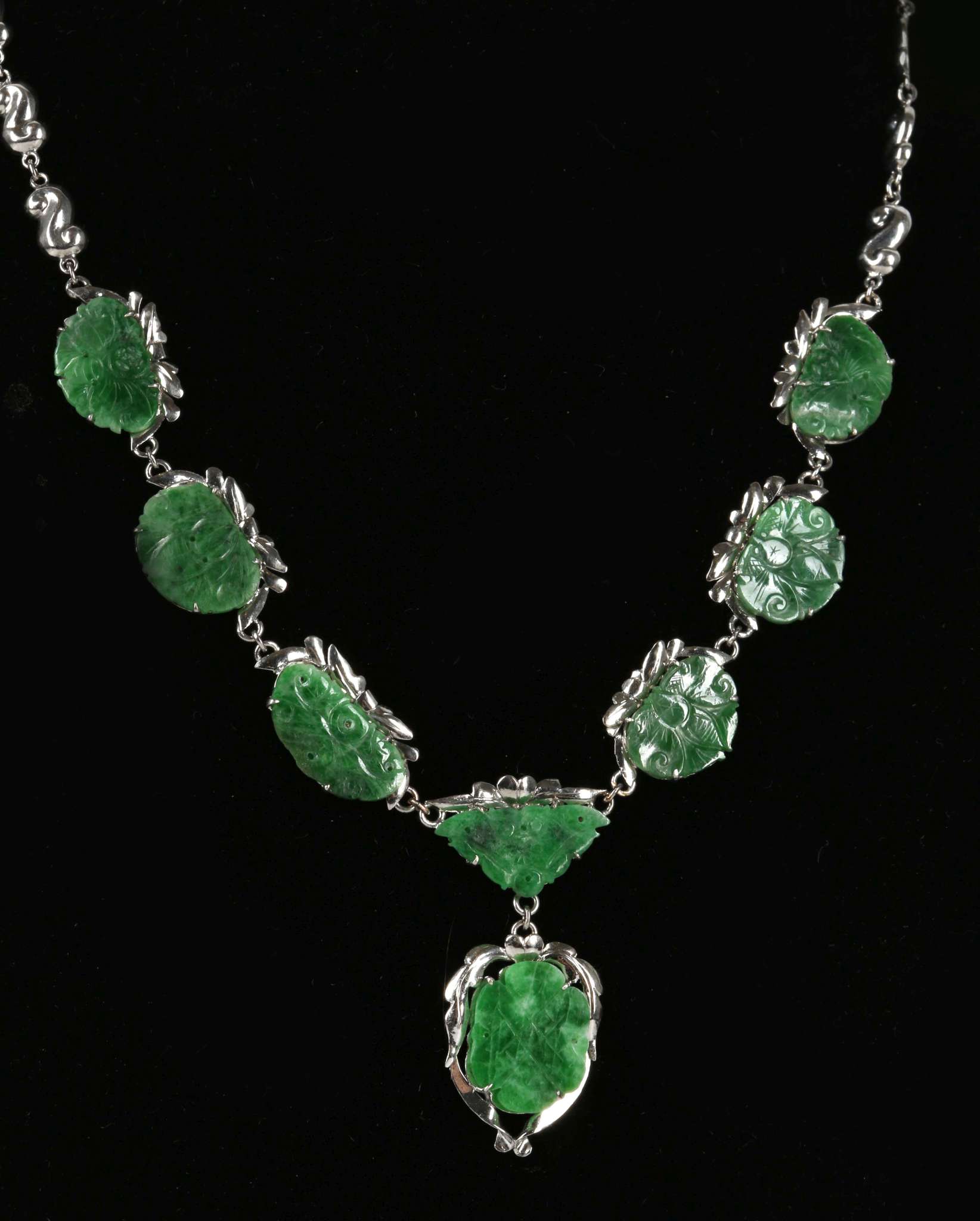 A 14ct white gold necklace set with carved jade panels