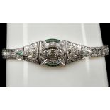 An Art Deco style white gold, diamond and emerald articulated bracelet