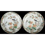 A PAIR OF CHINESE FAMILLE VERTE PLATES.  Kangxi.  Painted and gilded with a central medallion of two