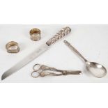 A Georg Jensen Bernadotte pattern silver spoon, a silver pair of grape scissors, two napkin rings