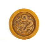 A CIRCULAR PALACE TILE, WADANG. Ming. Monochrome yellow glaze, moulded figure of a five claw