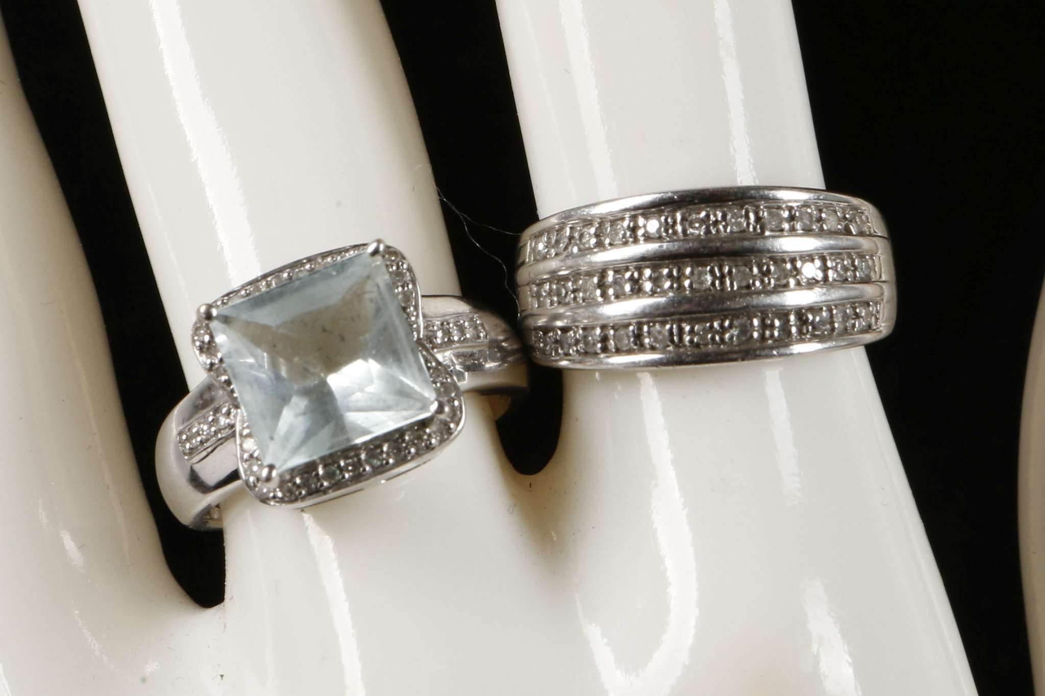 A 9ct white gold and diamond set ring together with a 9ct white gold blue stone and diamond set ring