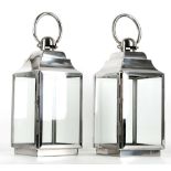 A pair of four glass storm lanterns