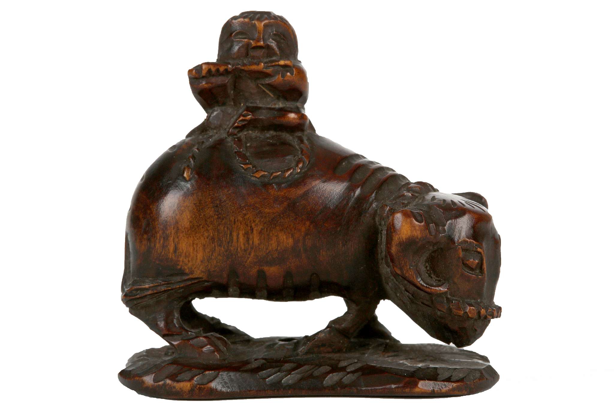 A JAPANESE OX AND BOX NETSUKE.After Okatomo, Kyoto, 19th Century. Carved as a youth riding a