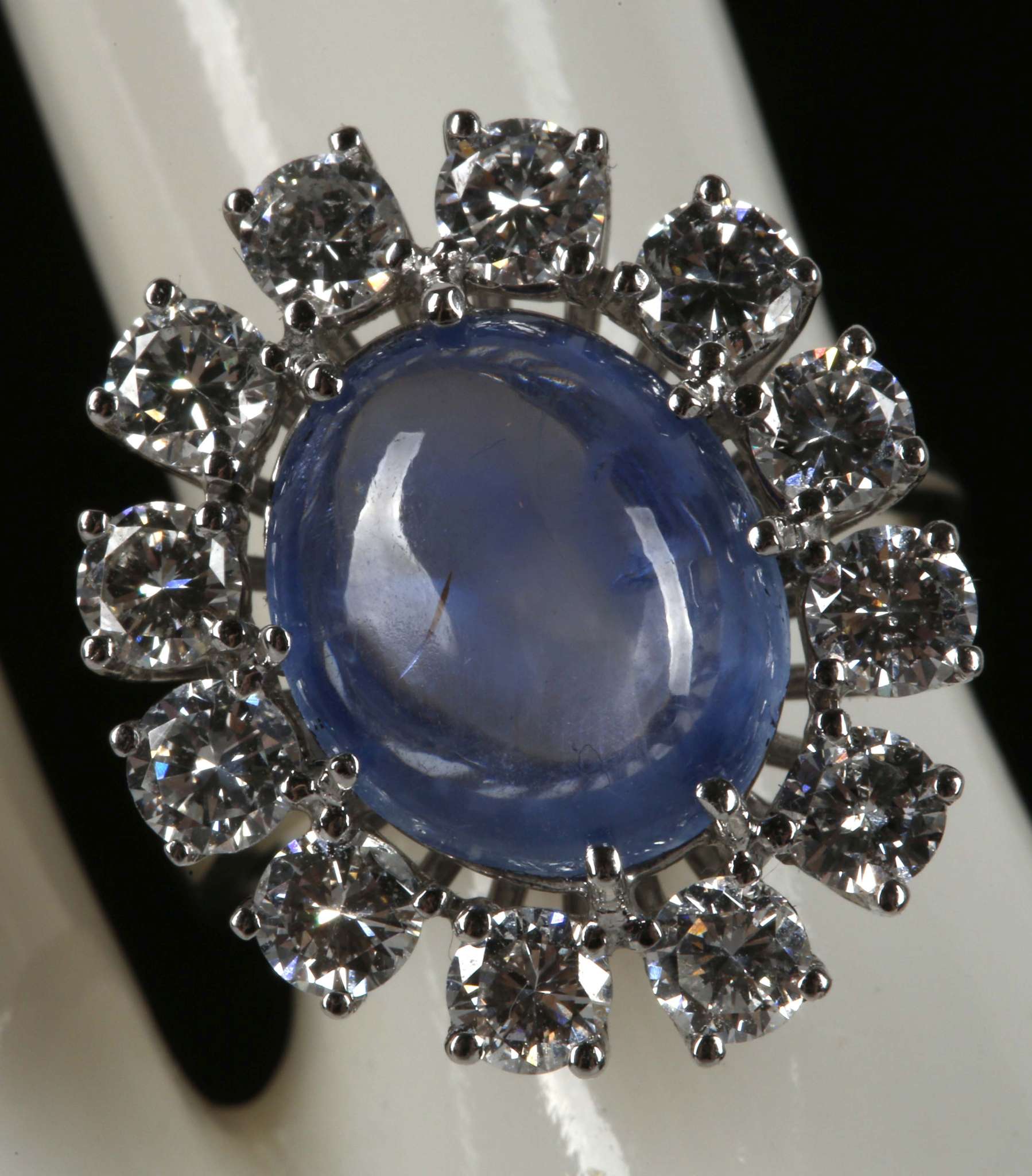 CAB, sapphire and diamond cluster ring set in 18ct white gold