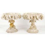 A pair of carved alabaster comports decorated with Berry and leaf on a tri-form pedestal on square