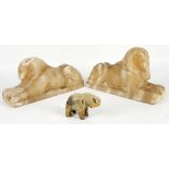 Two marble carvings of the Egyptian Sphinx, 22 and 23cm long, and an Indian elephant, 6.3cm (3)
