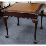 A mahogany Chippendale style card table with a tooled leather playing surface, chip and counter