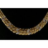 An 18ct yellow gold graduated curb link necklace set with diamonds within a white gold cartouche
