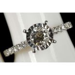 An 18ct white gold diamond solitaire with diamond set shoulders (0.86cts)