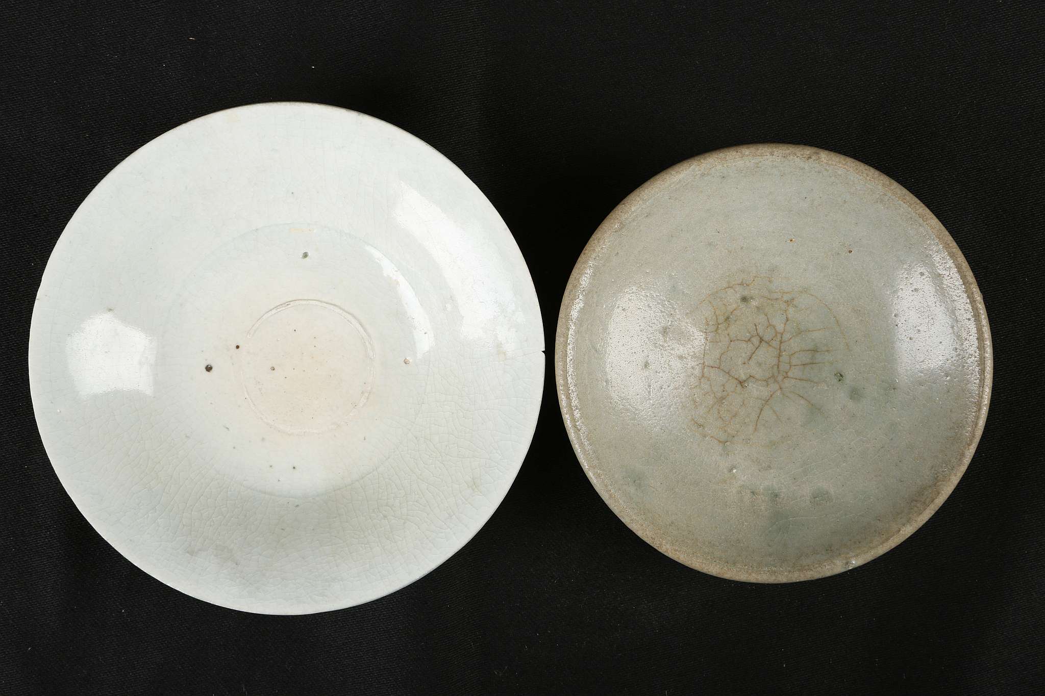 A CHINESE PALE CELADON BOWL TOGETHER WITH A QINGBAI BOWL. Song Dynasty. 12/14cm diameter. (2). 宋代