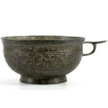 A MEDIEVAL ISLAMIC HIGH TIN BRONZE SHALLOW CUP. Of rounded form, a ring handle at one side with