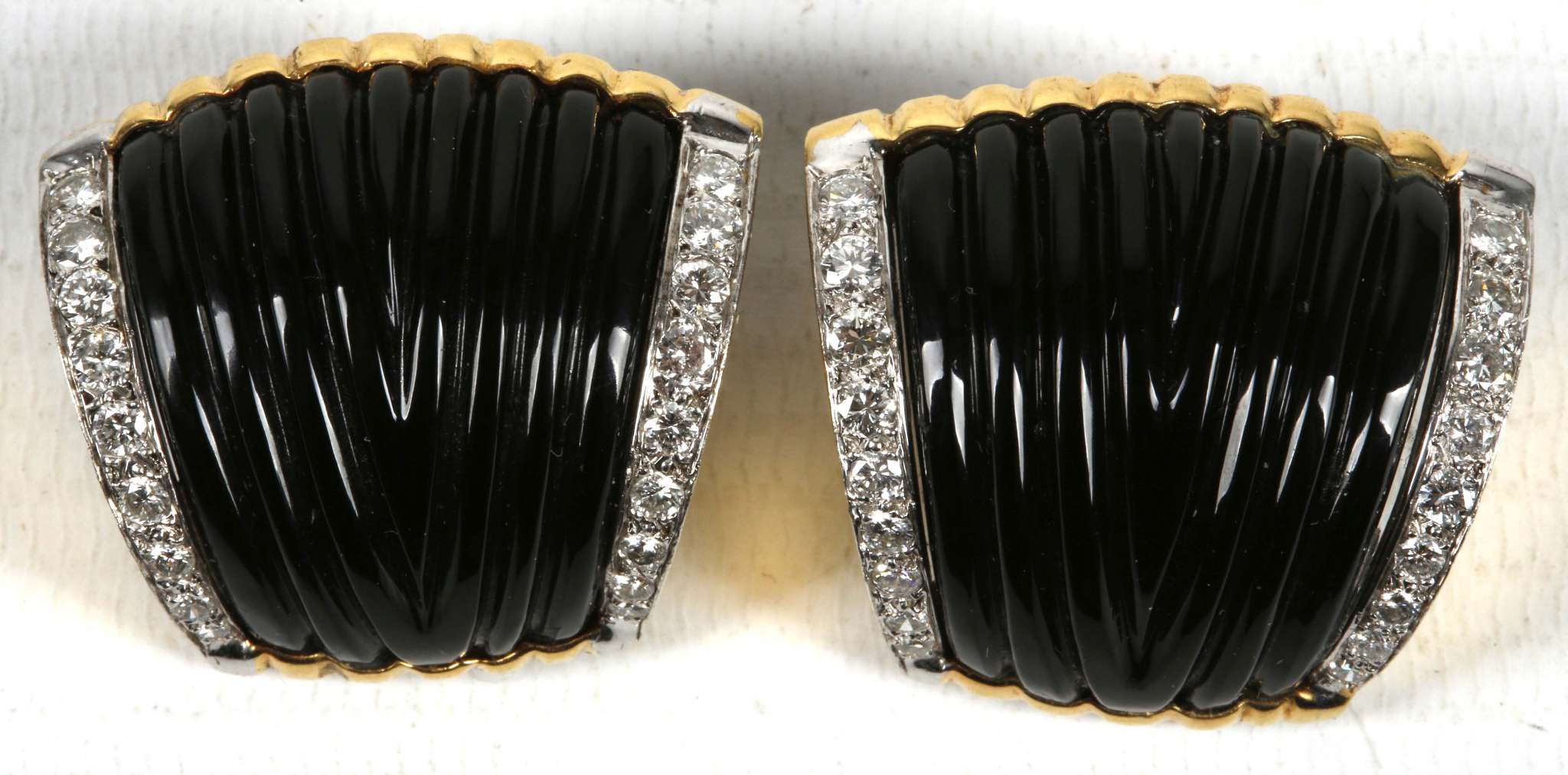 A  pair of onyx , diamond earrings set in yellow gold