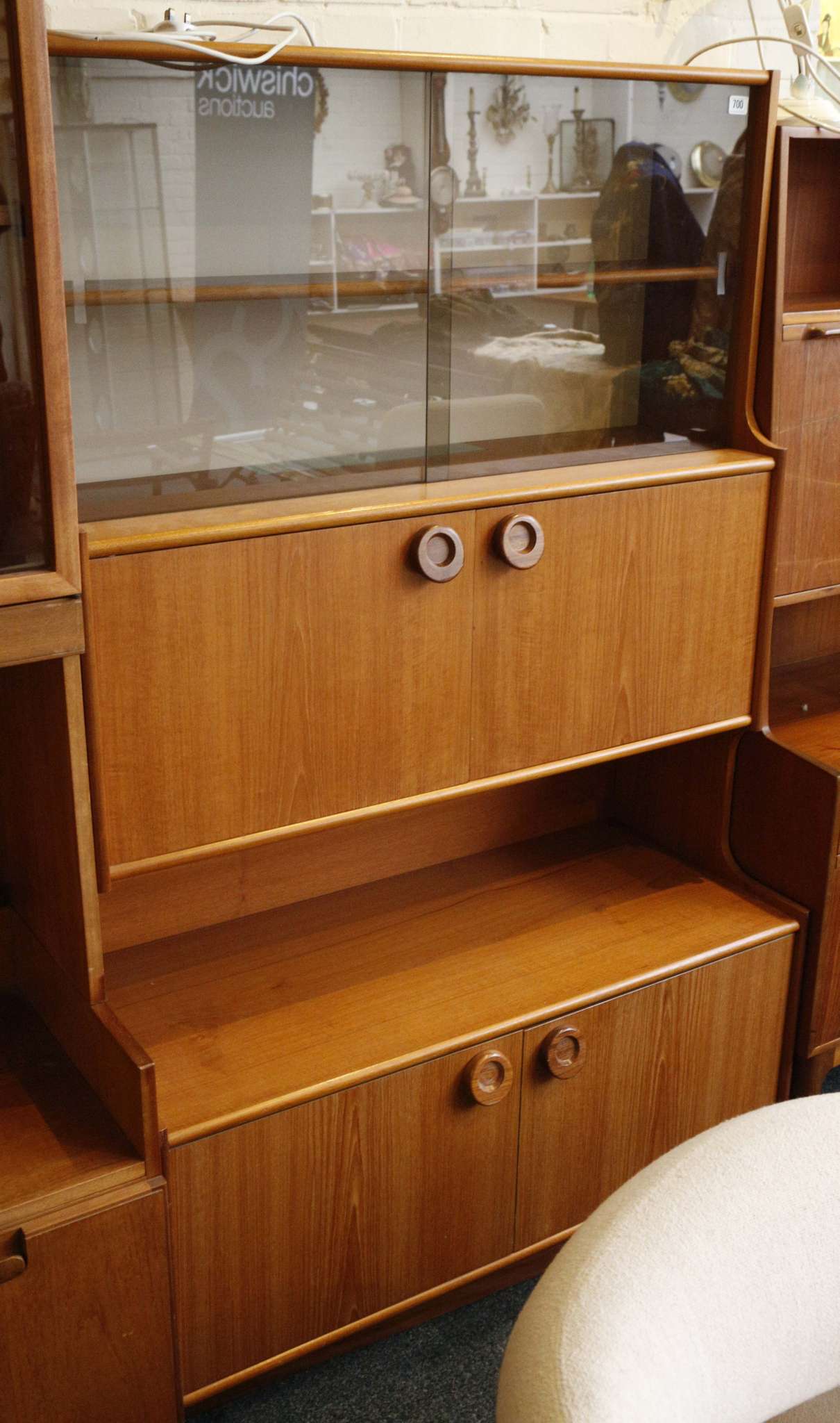 a 1970 G Plan cabinet with glazed sliding doors over cupboard doors and open recess, raised on stile