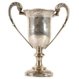 A CHINESE EXPORT SILVER TROPHY. Late Qing, c. 1900. On a circular pedestal foot with knopped stem,