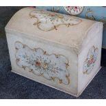 A single bed, the head and foot board decorated with flowers, together with a dome topped blanket