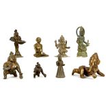 A COLLECTION OF EIGHT INDIAN MINIATURE BRONZE AND BRASS FIGURES. Including two kneeling figures of