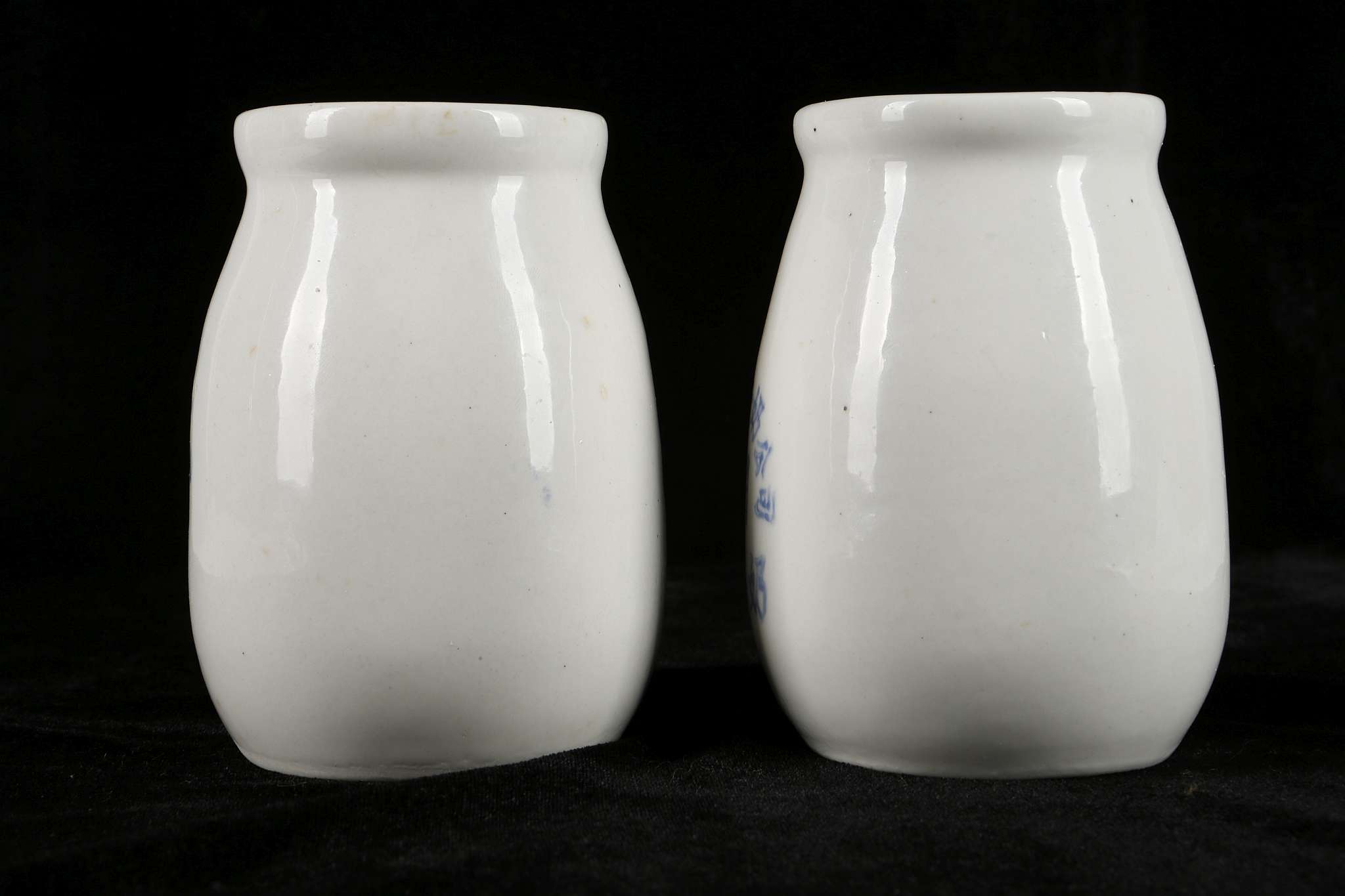 A PAIR OF CERAMIC MILK BOTTLES.  Mid 1960s.  Thickly potted, with a swelling body, a thick neck - Image 2 of 6