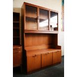 A 1970s teak sideboard display cabinet, with glazed cupboards over floor level cupboards.