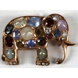 A brooch in the form of an elephant, set with various semi precious stones