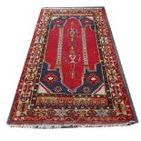 A North West Persian rug with red ground of running borders, together with another rug (2)