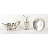 An Italian silver plannished lobed dish with floral handles and shaped feet, 27cm wide and a