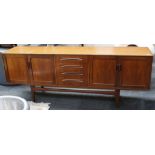 A G Plan teak sideboard, having 4 central drawers flanked by twin door cupboards at either end,