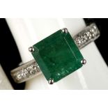 An 18ct white gold, emerald and diamond shouldered ring, emerald: 3.40ct, diamond: 0.47ct