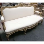 A French 19th century four seat sofa, carved floral decoration, scroll and acanthus arms, stub