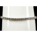 A 14k white gold and diamond tennis bracelet, set with 6.26cts of brilliant round cut stones