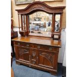 An Art Nouveau mirror back sideboard, arch pediment with dentil trim, 4 reeded columns with two open