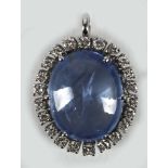 A sapphire and diamond cluster pendant in 18ct white gold