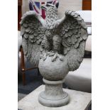 A pair of regal stone eagles, wings spread, perche