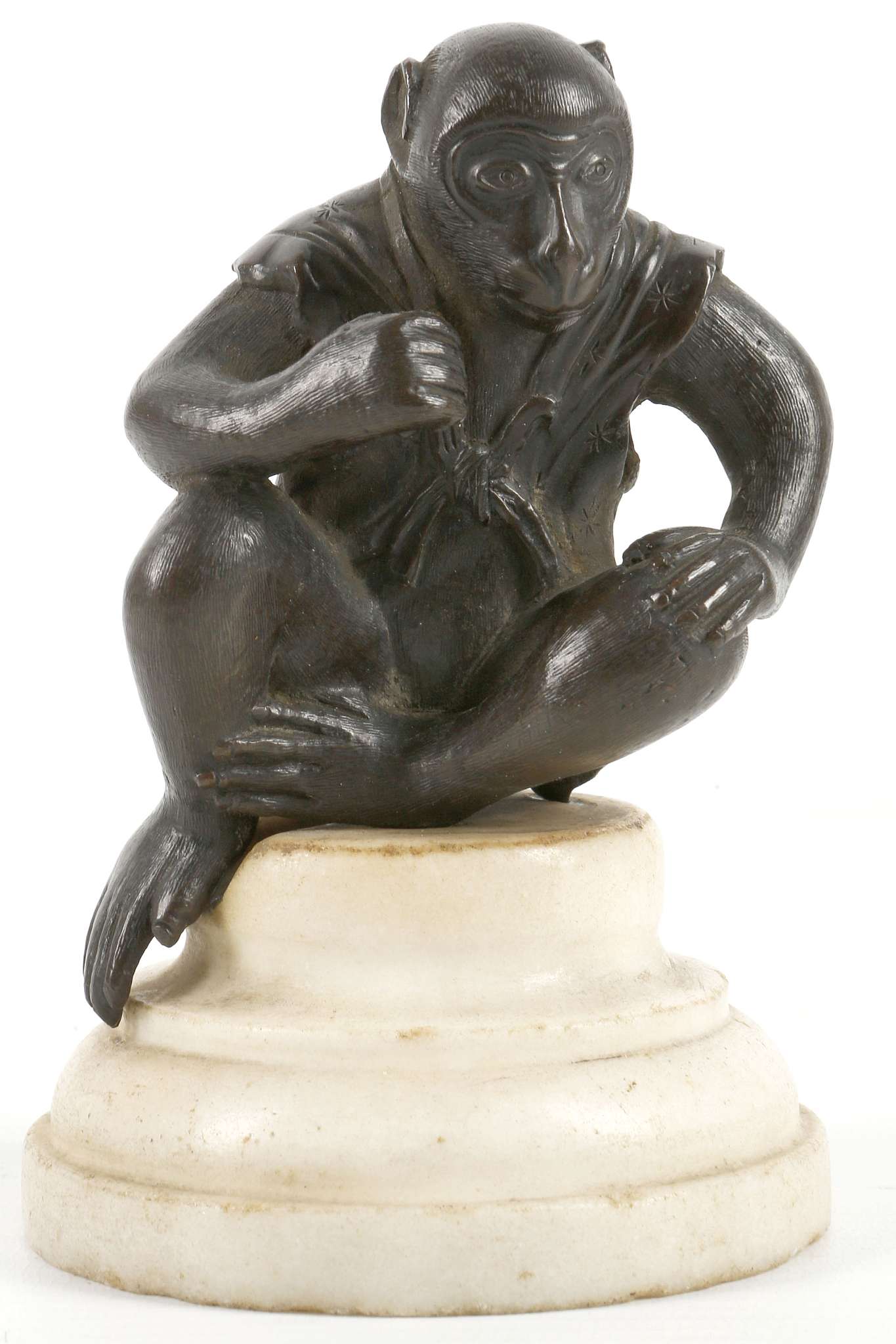 A JAPANESE BRONZE MODEL OF A SEATED MONKEY.  Late Meiji, 19th Century. The right knee raised