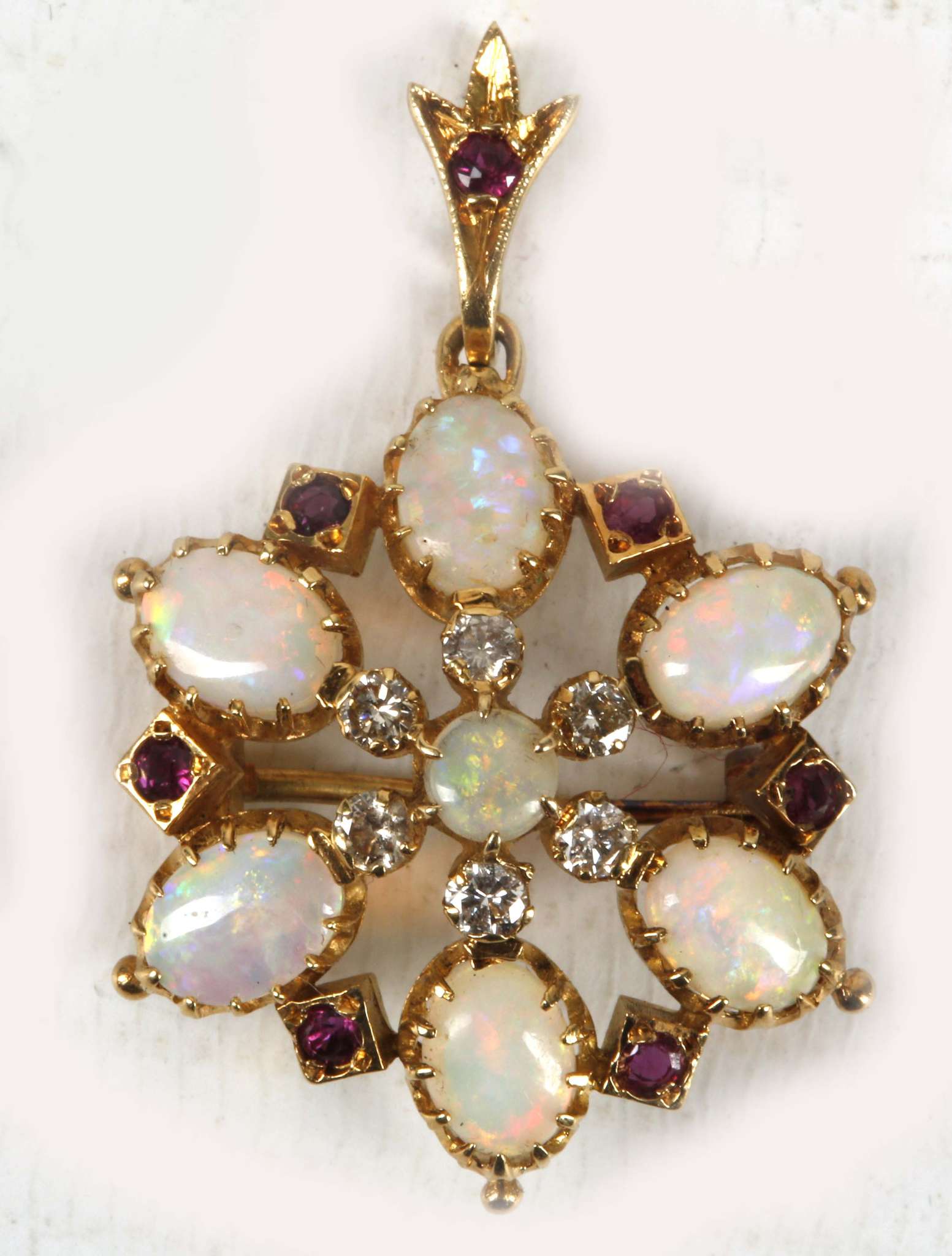 An antique opal, diamond and ruby pendant set in high carat gold