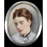 An Edwardian hallmarked silver frame portrait miniature brooch, depicting a young woman with blue