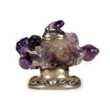 A CARVED AMETHYST BOX AND COVER, MOUNTED IN SILVER BY EDWARD FARMER.  Late Qing, 19th Century, the