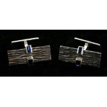 A pair of 18ct white gold baguette sapphire set cuff links