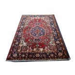 An old Hamadan rug, with red ground and running border, 210 x 152cm