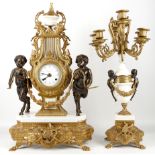 A gilt brass and marble Empire style Lyre clock, having a marble and gilt urn finial, clock