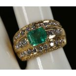 An emerald and diamond dress ring set in 18ct yellow gold
