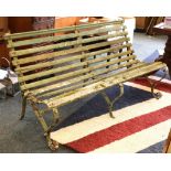 An Edwardian roll back garden bench, scroll supports, 150cm wide