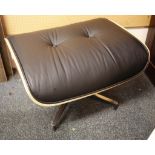 A laminated rosewood and black leather upholstered footstool on a swiveling base